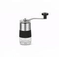 Molino manual para café mini de acero inoxidable con depósito de vidrio y manivela desmontable para moler café en grano.